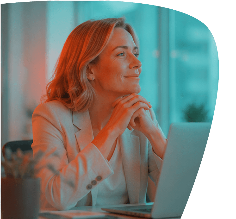 A woman smiling while looking out of a window