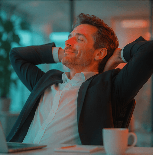 A manager leaning back at their desk